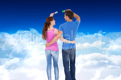 Composite image of couple both about to paint