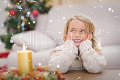 Composite image of cute little girl smiling at christmas