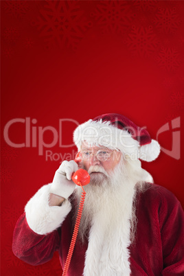 Composite image of santa on his red phone