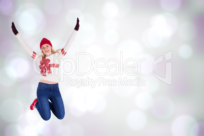 Composite image of festive blonde in christmas jumper