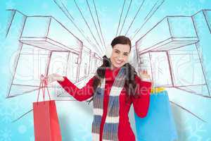 Composite image of brunette in winter clothes holding shopping b