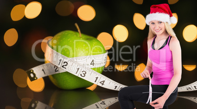 Composite image of fit festive young blonde measuring her thigh