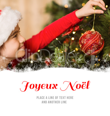 Composite image of festive little girl hanging a christmas decor