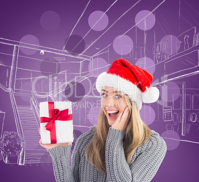 Composite image of festive blonde holding christmas gift