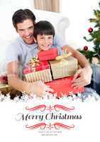 Composite image of happy father and son holding christmas presen