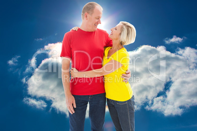 Composite image of happy mature couple hugging and smiling