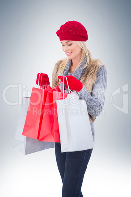 Blonde in winter clothes with shopping bags