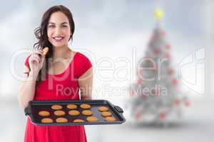 Composite image of happy brunette eating hot cookies