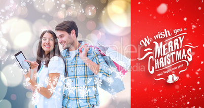 Composite image of happy couple with shopping bags