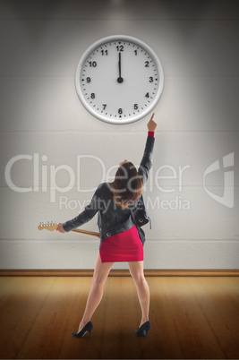 Composite image of brunette in biker jacket playing guitar