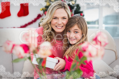 Composite image of little girl giving her mother a christmas gif