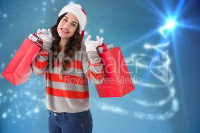Composite image of cheerful brunette holding shopping bags full