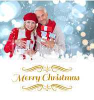 Composite image of happy festive couple with gifts