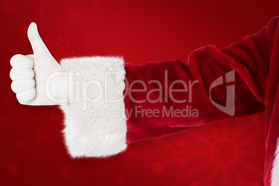 Composite image of father christmas gives a thumb up