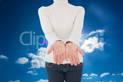 Composite image of woman standing with her hands out