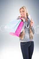 Blonde in winter clothes holding shopping bags