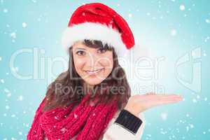 Composite image of festive young woman presenting with hand