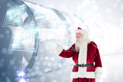 Composite image of santa shows something to camera