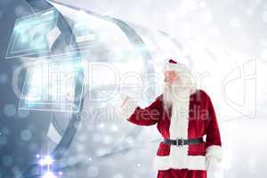 Composite image of santa shows something to camera