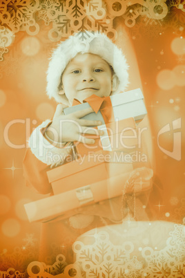 Composite image of cute little boy in santa costume