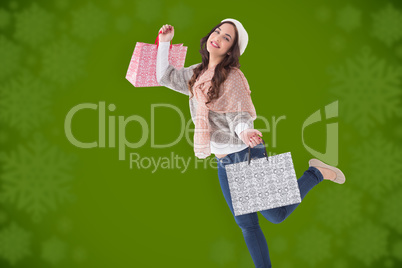 Composite image of pretty brunette posing with shopping bags