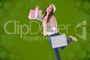 Composite image of pretty brunette posing with shopping bags
