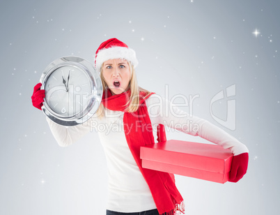 Festive blonde holding a clock and gift