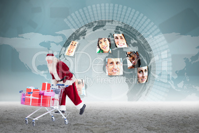 Composite image of santa pushing a shopping cart