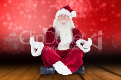 Composite image of santa claus sits and meditates