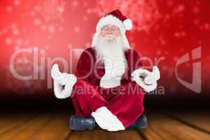 Composite image of santa claus sits and meditates