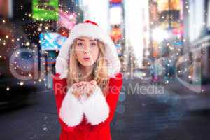 Composite image of pretty santa girl blowing over hands