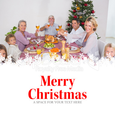 Composite image of family raising their glasses at christmas