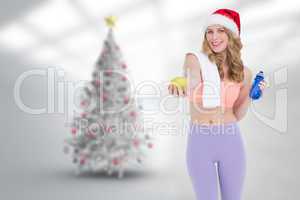 Composite image of festive fit blonde smiling at camera