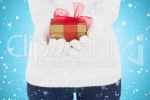 Composite image of woman in white gloves holding gift