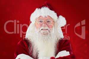 Composite image of santa smiles with folded arms