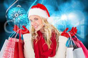 Composite image of happy festive blonde with shopping bags