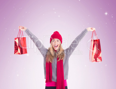 Festive blonde holding shopping bags