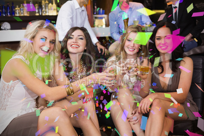 Composite image of pretty friends having a drink together