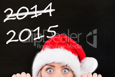 Composite image of festive blonde showing large poster