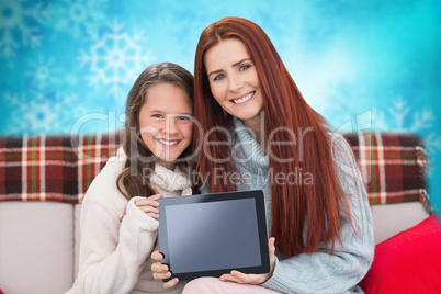 Composite image of mother and daughter showing tablet