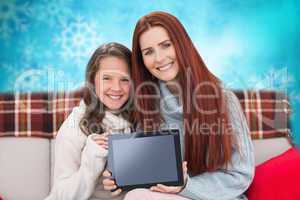 Composite image of mother and daughter showing tablet