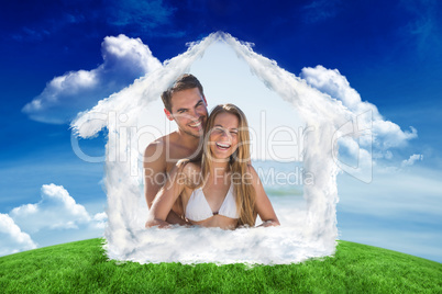 Composite image of athletic couple smiling at camera and hugging