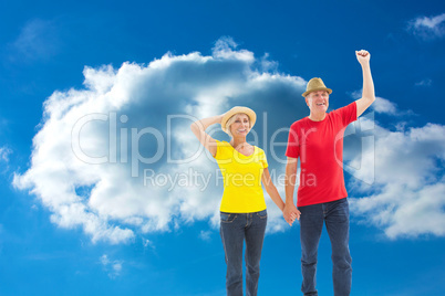 Composite image of mature couple walking and holding hands