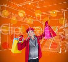 Composite image of blonde in winter clothes holding shopping bag