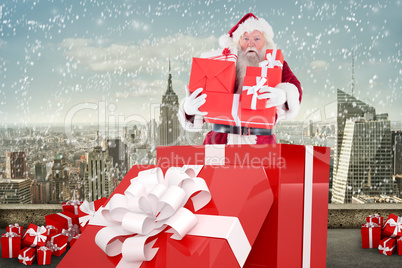 Composite image of santa standing in large gift