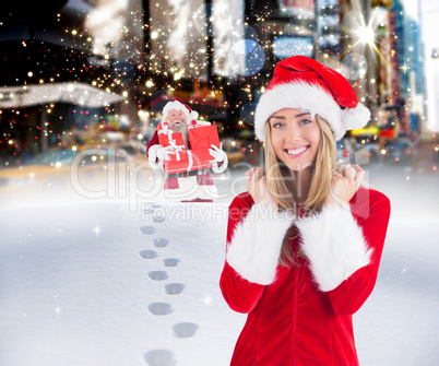 Composite image of pretty santa girl smiling at camera