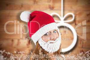 Composite image of pretty redhead in santa hat and beard