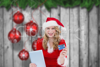 Composite image of woman holding a tablet