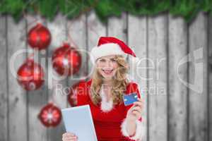 Composite image of woman holding a tablet