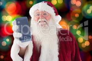 Composite image of santa claus shows a smartphone